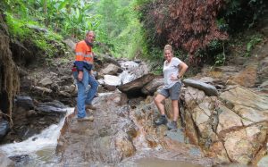 Darryl Mapleson and colleague standing on rocks by stream