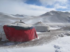 Yurts in bleak mountain terrain